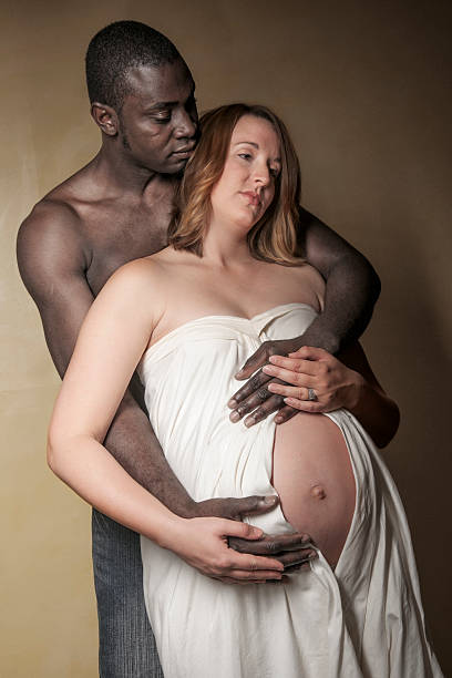 Husband and wife share a quiet moment anticipating the birth of their baby